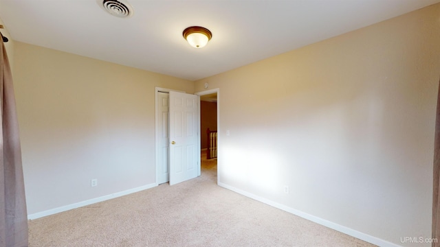 spare room with light carpet