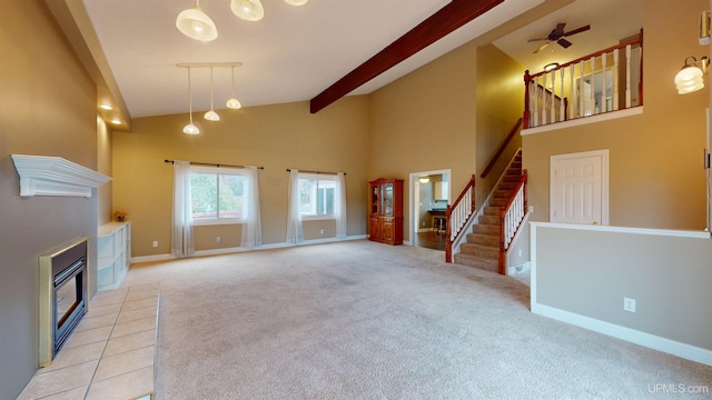 unfurnished living room with light carpet, high vaulted ceiling, ceiling fan, and a tiled fireplace