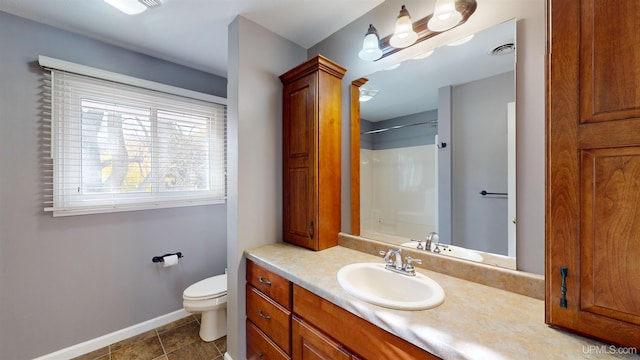 bathroom featuring tile patterned floors, vanity, and toilet