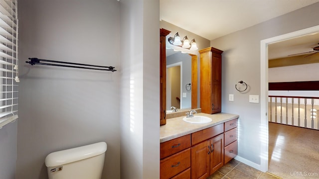 bathroom featuring ceiling fan, tile patterned flooring, vanity, and toilet