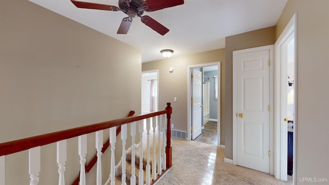 hallway featuring light colored carpet