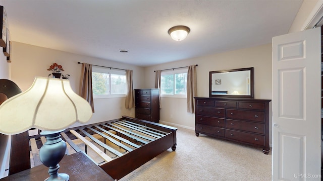 bedroom featuring light colored carpet