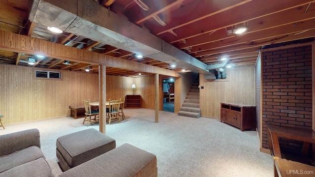 basement featuring carpet flooring and wooden walls