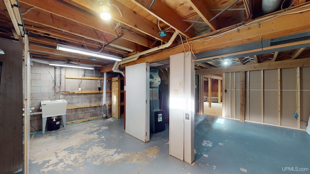 basement with heating unit and sink