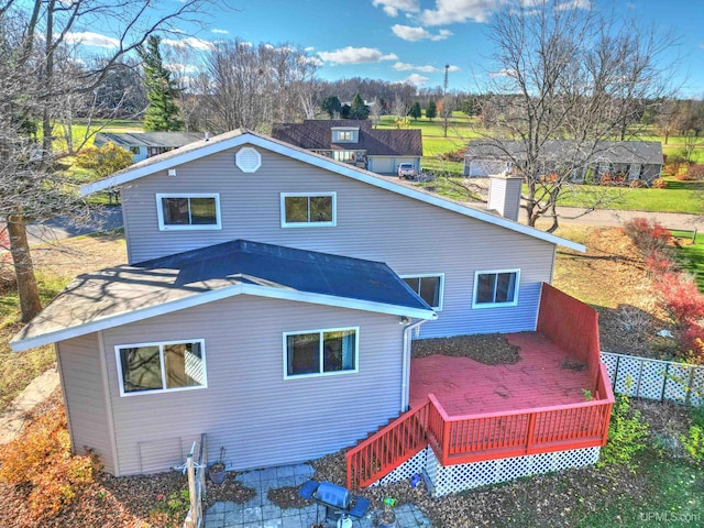 back of house with a deck