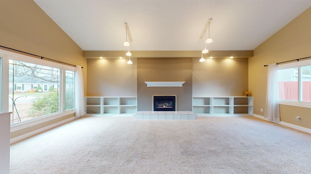 unfurnished living room with carpet, a fireplace, and high vaulted ceiling