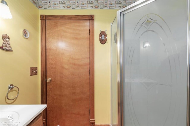 bathroom featuring vanity and an enclosed shower