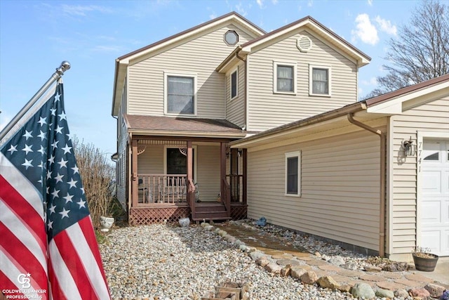 front facade with a porch and a garage