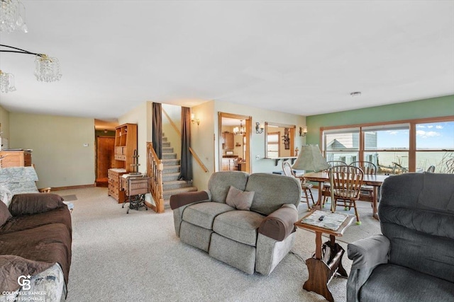 living room with light carpet, a water view, and a notable chandelier