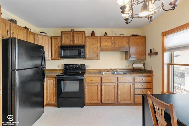 kitchen featuring sink, an inviting chandelier, plenty of natural light, and black appliances