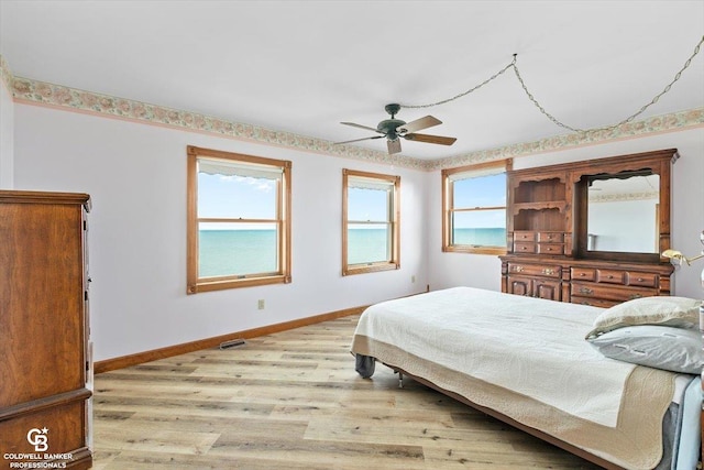 bedroom with ceiling fan and light hardwood / wood-style floors