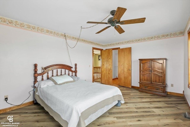 bedroom with ceiling fan and wood-type flooring