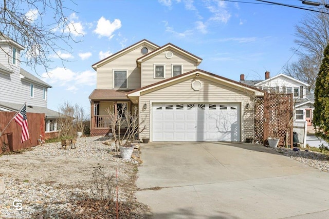 view of property featuring a porch and a garage