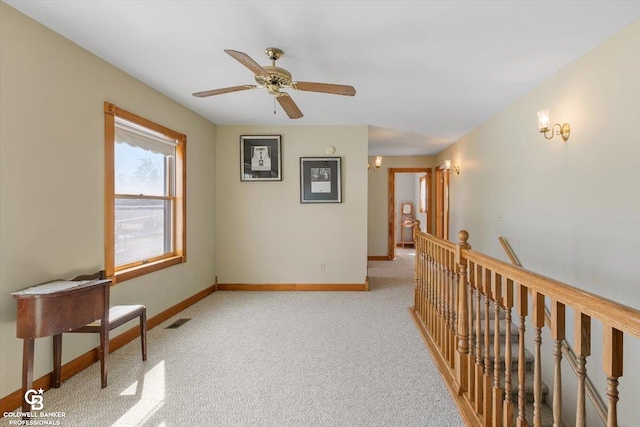 hallway featuring light colored carpet