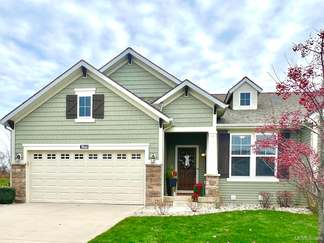 craftsman-style house featuring a garage and a front yard