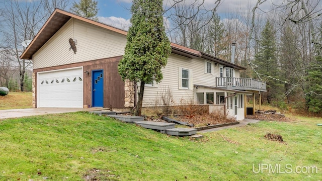 view of front of house with a front yard, a balcony, and a garage