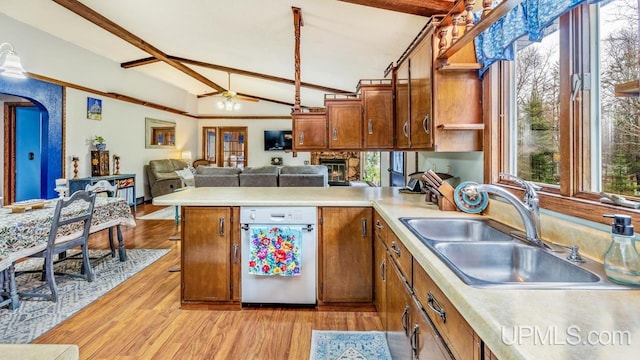 kitchen featuring sink, vaulted ceiling with beams, ceiling fan, light wood-type flooring, and kitchen peninsula