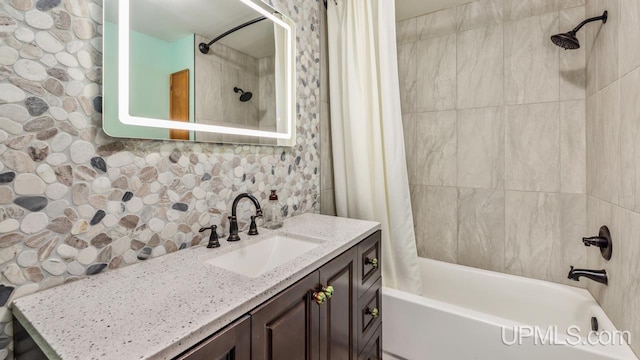 bathroom featuring decorative backsplash, shower / bath combo with shower curtain, and vanity