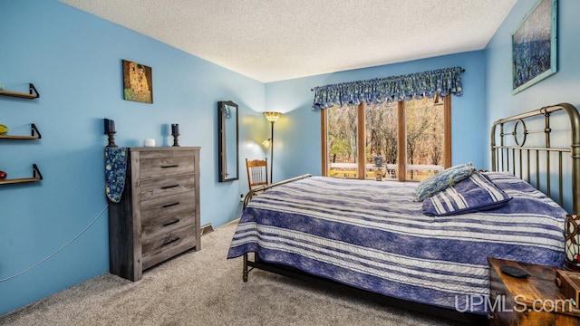 bedroom featuring a textured ceiling and light carpet