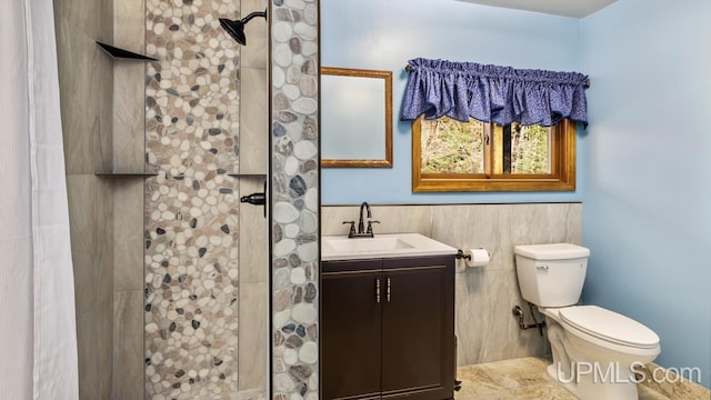 bathroom with walk in shower, vanity, and toilet