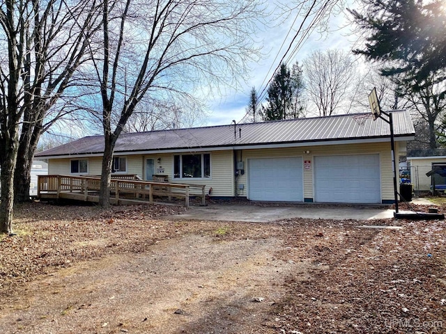 ranch-style house featuring a garage and a deck