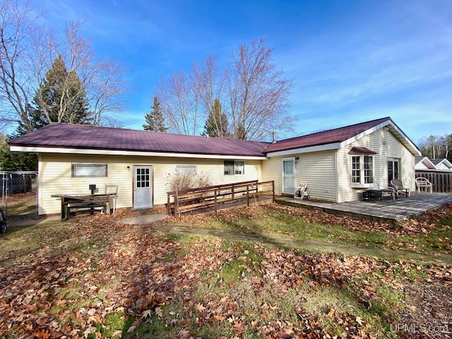 back of property featuring a deck