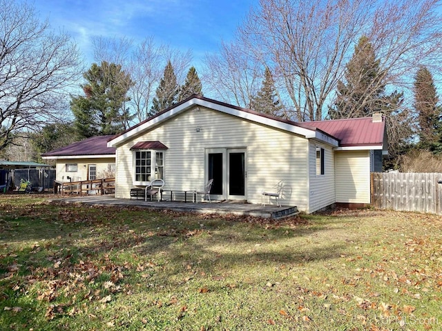 back of house with a lawn and a patio area