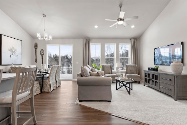 living room with wood-type flooring, lofted ceiling, and a healthy amount of sunlight