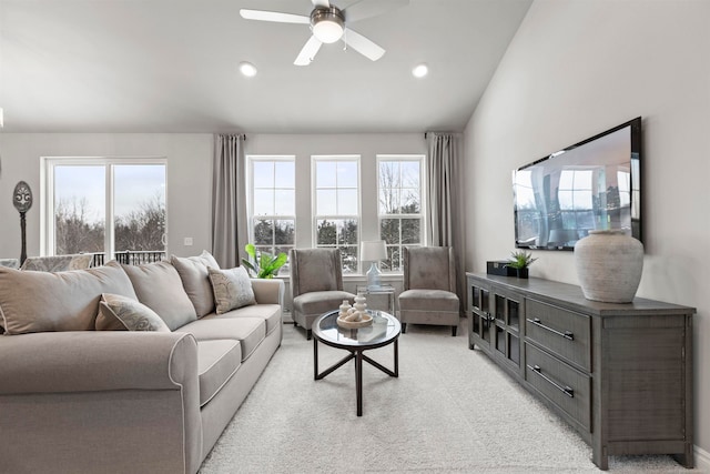 living room featuring ceiling fan, plenty of natural light, light carpet, and vaulted ceiling