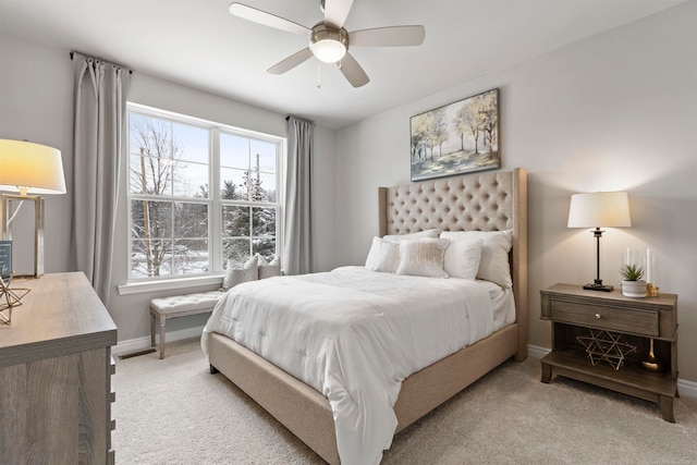 carpeted bedroom featuring ceiling fan and multiple windows