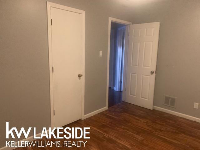 unfurnished bedroom featuring dark wood-type flooring