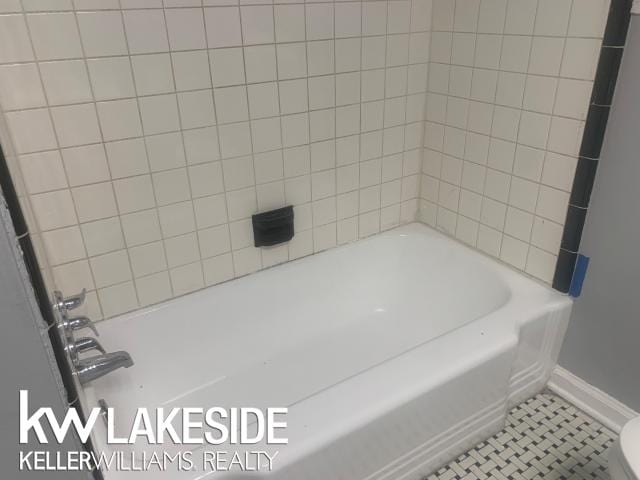 bathroom featuring toilet and tile patterned floors