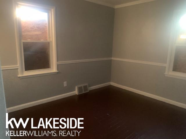 spare room featuring dark wood-type flooring