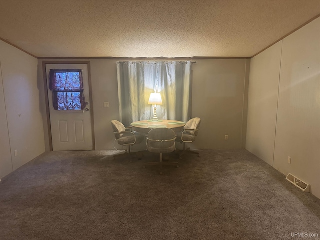 unfurnished dining area with carpet flooring, crown molding, and a textured ceiling