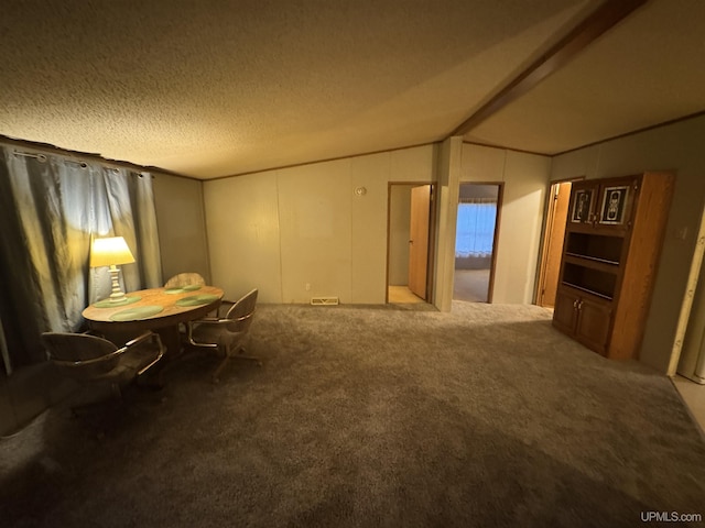 interior space with carpet flooring, a textured ceiling, and vaulted ceiling