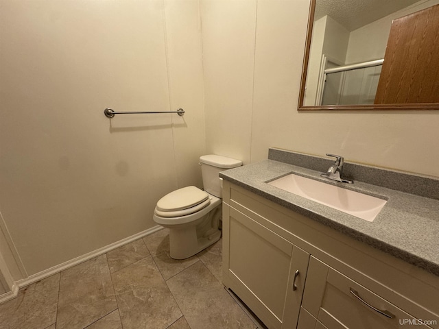 bathroom featuring vanity, a shower with door, tile patterned floors, toilet, and a textured ceiling