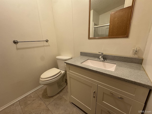 bathroom featuring vanity, tile patterned flooring, toilet, a textured ceiling, and a shower with shower door