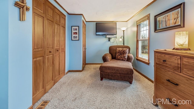 living area featuring crown molding and light colored carpet