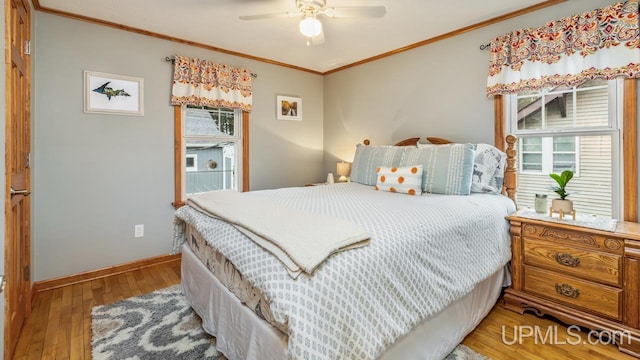 bedroom with ceiling fan, wood-type flooring, and crown molding