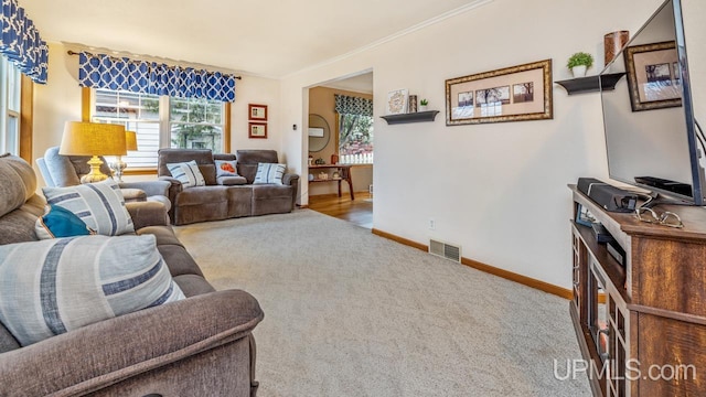 living room with light carpet and ornamental molding