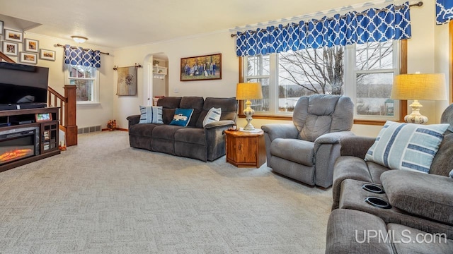 living room featuring carpet floors and ornamental molding