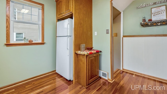 kitchen with wood-type flooring and white fridge