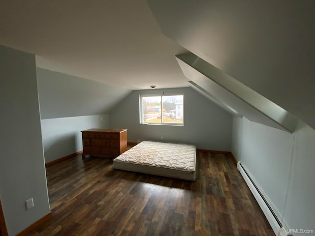 bedroom featuring baseboard heating, dark wood-type flooring, and lofted ceiling