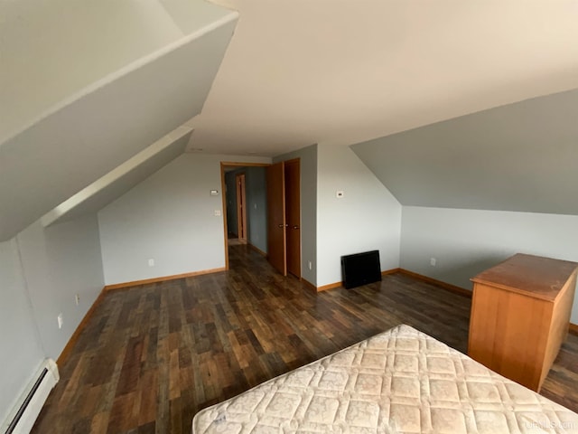 bonus room featuring baseboard heating, dark hardwood / wood-style flooring, and lofted ceiling