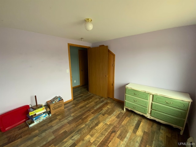 bedroom with dark hardwood / wood-style floors