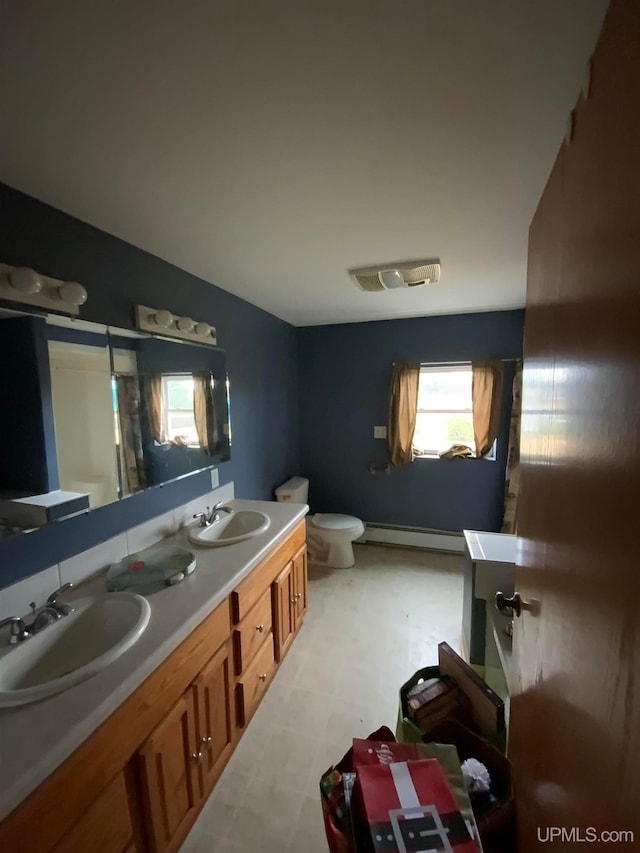 bathroom featuring vanity, a baseboard radiator, and toilet