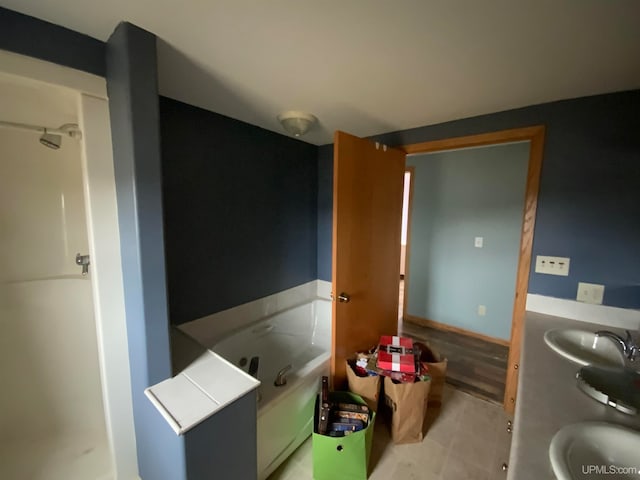 bathroom featuring vanity and a tub