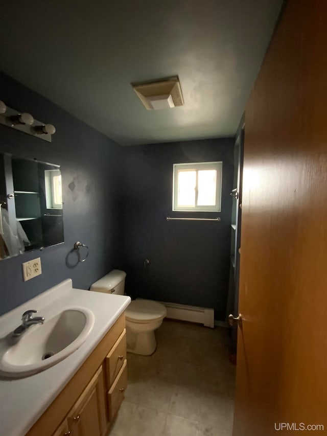 bathroom featuring vanity, toilet, and a baseboard heating unit