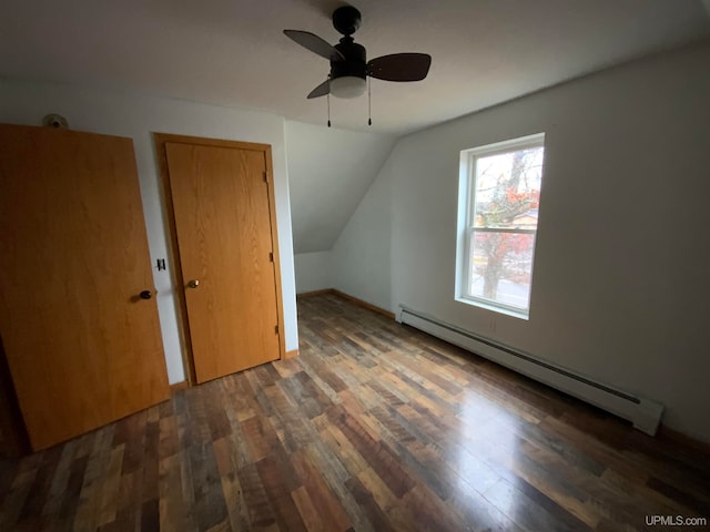 bonus room featuring dark hardwood / wood-style flooring, a baseboard radiator, vaulted ceiling, and ceiling fan