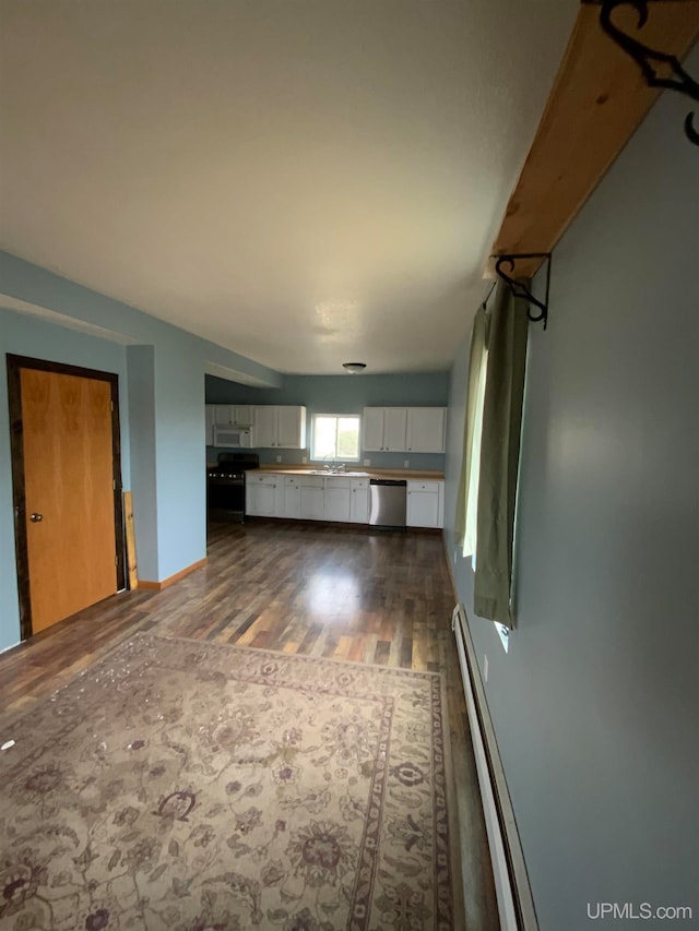 interior space with dark hardwood / wood-style floors and a baseboard heating unit